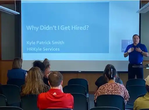 Kyle Patrick Smith speaking at an event